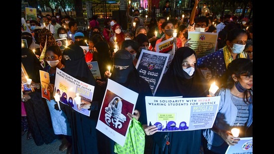 Citizens hold placards and candles in support of the hijab-wearing students, Bengaluru, February 19, 2022 (PTI)