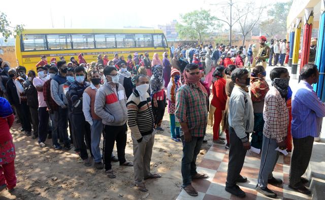 Voters lined up outside a polling booth in Jhujhar village. Just like 2017, rural areas once again saw bigger crowds. (Ravi Kumar/HT)