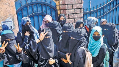 Some students were seen walking up to the gates of the college where professors checked and took in their assignments. (PTI) Some students were seen walking up to the gates of the college where professors checked and took in their assignments. (PTI)