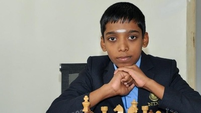 This handout photograph released by the Velammal School on June 25, 2018, and taken on February 12, 2018, shows Indian chess prodigy Rameshbabu Praggnanandhaa posing for a photograph with a chess board at the school in Chennai. (PTI)