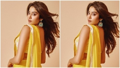 Janhvi's yellow satin saree came with white zari borders. She paired it with a sleeveless yellow blouse intricately detailed in white zari in floral patterns. (Instagram/@janhvikapoor)