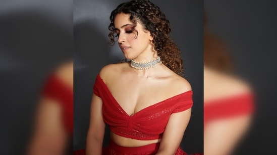 Sanya Malhotra posed like a princess in her gorgeous embroidered lehenga which featured sequins work, an off-shoulder blouse with a plunging neckline and a see-through dupatta.(Instagram/@sukritigrover)