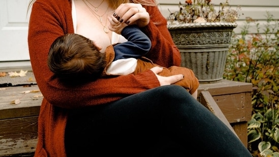 Keep your back straight: Whenever you feed your baby your back needs to be straight and supported. Don't bend too much over your baby. Rather bring the baby close to you.(Pexels)
