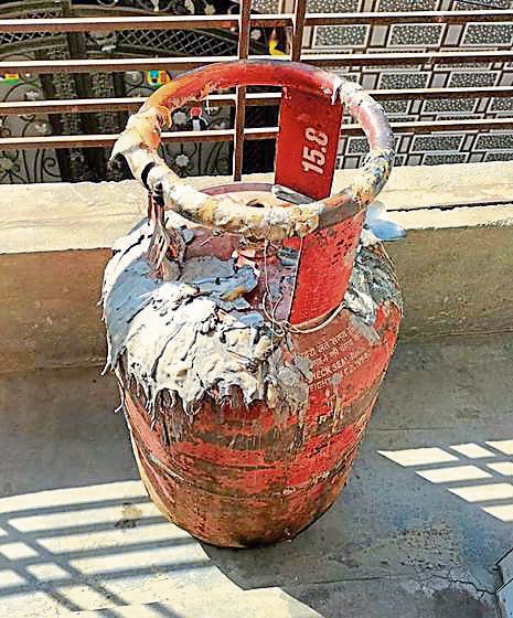 The gas cylinder that caught fire in Kot Mangal Singh area in Ludhiana on Monday. (HT Photo) The gas cylinder that caught fire in Kot Mangal Singh area in Ludhiana on Monday. (HT Photo)