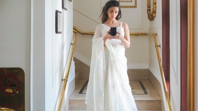 The strappy blouse was teamed with a matching petticoat and sheer white saree that too sported tiny multi-coloured polka dots all over. Alia completed her attire with a pair of monochrome heels. (Instagram/aliaabhatt) The strappy blouse was teamed with a matching petticoat and sheer white saree that too sported tiny multi-coloured polka dots all over. Alia completed her attire with a pair of monochrome heels. (Instagram/aliaabhatt)