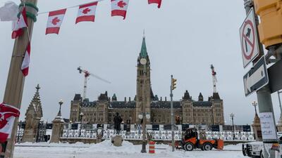 City employees clean up Wellington Street in front of Parliament Hill, previously occupied by the Freedom Convoy, in Ottawa, Ontario, Canada. (AFP) City employees clean up Wellington Street in front of Parliament Hill, previously occupied by the Freedom Convoy, in Ottawa, Ontario, Canada. (AFP)
