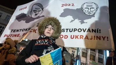 A young protester holding a Ukrainian flag takes part in a demonstration in support to Ukraine. (AFP) A young protester holding a Ukrainian flag takes part in a demonstration in support to Ukraine. (AFP)