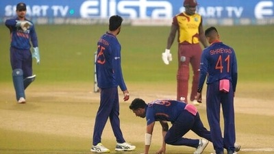 Deepak Chahar reacts in pain after bowling a delivery during the third T20I between India and West Indies in Kolkata. (AP)