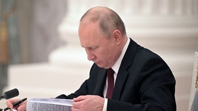 Russian President Vladimir Putin signs documents, including a decree recognising two Russian-backed breakaway regions in eastern Ukraine as independent entities, during a ceremony in Moscow, Russia, in this picture released February 21, 2022. Sputnik/Alexey Nikolsky/Kremlin via REUTERS (via REUTERS)