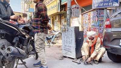 Mr Singh is sitting on his haunches in a corner of the intersection.