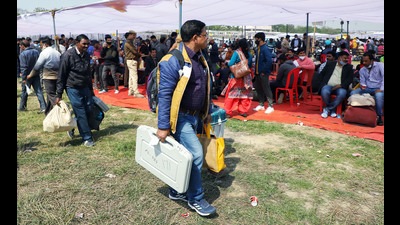 Polling officials carrying Electronic Voting Machines and other polling equipment after collecting it from the distribution centre, for the fourth phase of the Uttar Pradesh Assembly Election in Lucknow on Tuesday. (Agency) Polling officials carrying Electronic Voting Machines and other polling equipment after collecting it from the distribution centre, for the fourth phase of the Uttar Pradesh Assembly Election in Lucknow on Tuesday. (Agency)