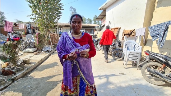 Village head of Bela Persua, a Tharu tribe village of Lakhimpur Kheri district, Lakshmi Devi showing SIM card of a Nepal telecom company. (HT)