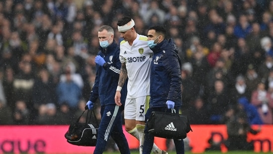 Leeds United's German defender Robin Koch reacts as he leaves the pitch after receiving medication following a collision with Manchester United's Scottish midfielder Scott McTominay.(AFP)