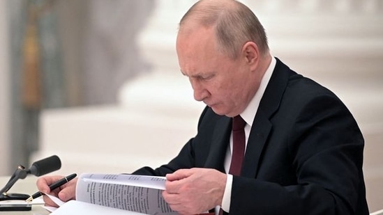 Russian President Vladimir Putin signs documents, including a decree recognising two Russian-backed breakaway regions in eastern Ukraine as independent entities, during a ceremony in Moscow, Russia, in this picture released February 21, 2022. Sputnik/Alexey Nikolsky/Kremlin via REUTERS ATTENTION EDITORS - THIS IMAGE WAS PROVIDED BY A THIRD PARTY.(via REUTERS)