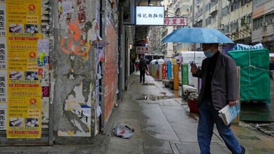 A man wearing a face mask, walks on a street in Hong Kong.(AP)