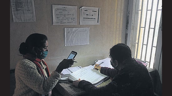 Health staff relying on a mobile phone’s torchlight to enter patient details at the Sector-19 Government Dispensary in Chandigarh. (Ravi Kumar/HT) Health staff relying on a mobile phone’s torchlight to enter patient details at the Sector-19 Government Dispensary in Chandigarh. (Ravi Kumar/HT)