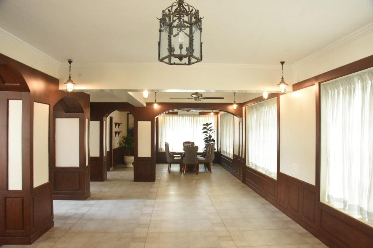 A view of a large hall and the dining space at one end.