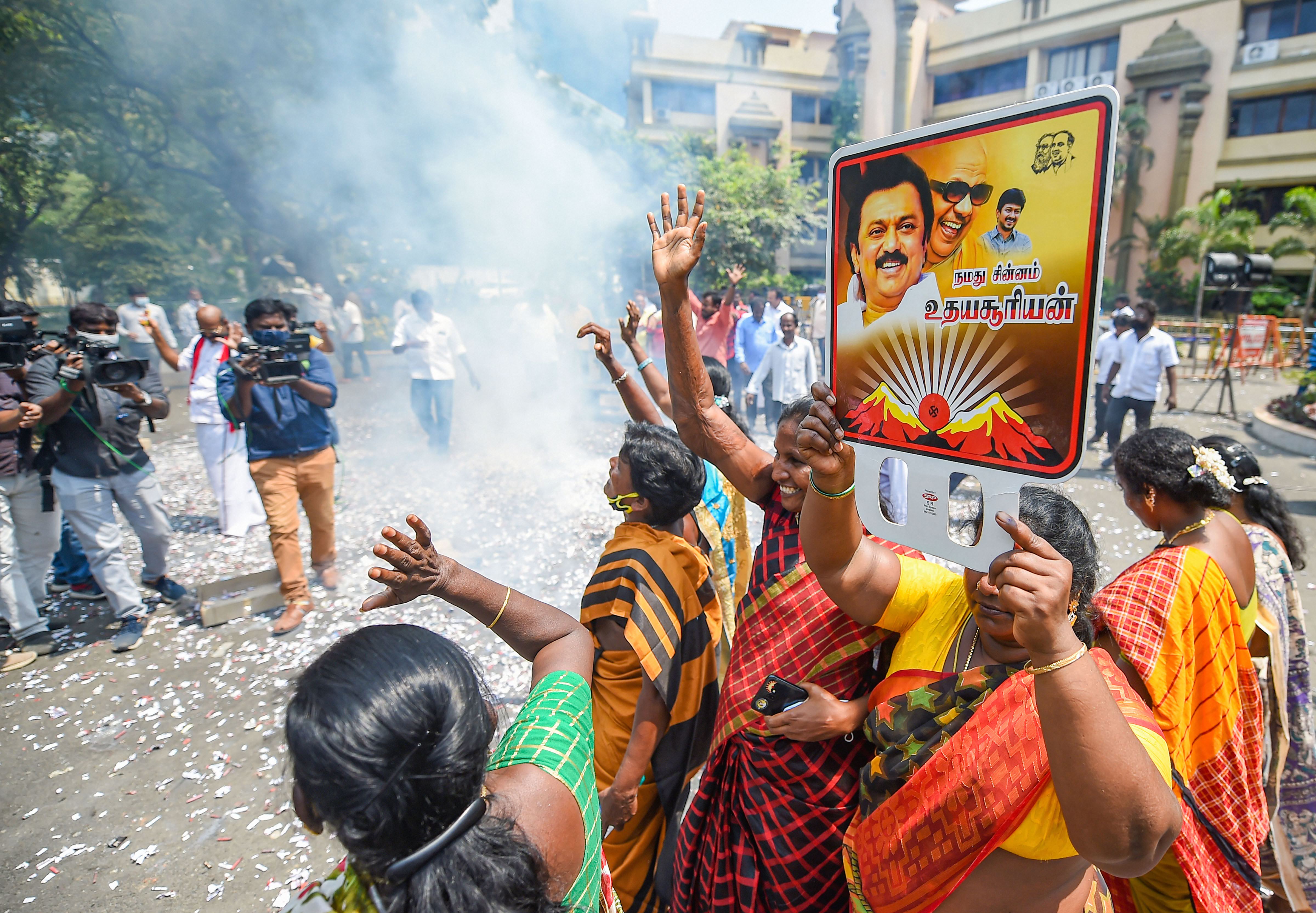 DMK party workers holding placards of Party President and Tamil Nadu CM M.K Stalin, celebrate after the party's lead in the local body elections, at the party headquarters, in Chennai.&nbsp; (PTI)