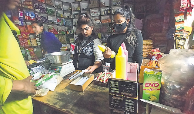 Residents buying candles at a shop in Manimajra amid the power outage. (Sant Arora/HT)