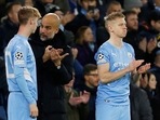 Cole Palmer with Manchester City manager Pep Guardiola before coming on as a substitute to replace Phil Foden while Oleksandr Zinchenko looks on.