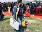 Polling officials carrying EVMs and other equipment for the fourth phase of the Uttar Pradesh Assembly Election in Lucknow on Tuesday. (Agency)
