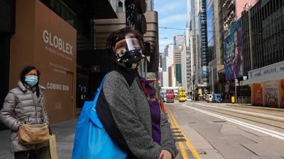 People wearing face masks walk at a downtown street in Hong Kong. (AP) People wearing face masks walk at a downtown street in Hong Kong. (AP)