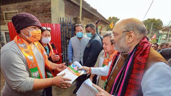 Union home minister Amit Shah during a door to door campaign for assembly polls, in Churachandpur (Manipur) on Wednesday. (PTI)