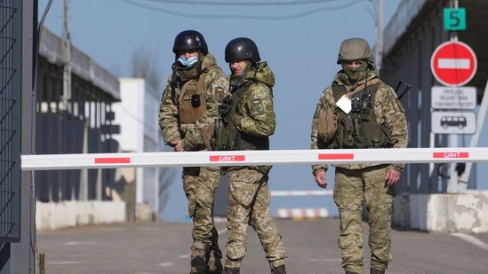 Ukrainian border guards stand at a checkpoint from territory controlled by Russia-backed separatists to the territory controlled by Ukrainian forces in Novotroitske, eastern Ukraine.&nbsp;(AP)