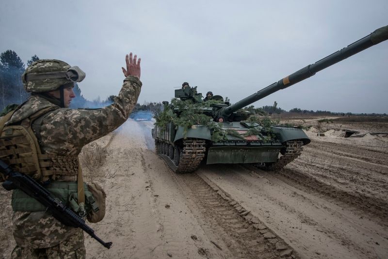 Ukrainian service members take part in tactical drills at a training ground in an unknown location in Ukraine. (Reuters)