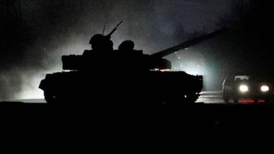 A tank drives along a street after Russian President ordered the deployment of Russian troops in eastern Ukraine.