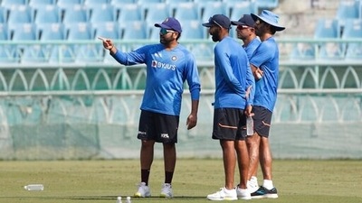 India's captain Rohit Sharma, left, interacts with head coach Rahul Dravid, second right, and batting coach Vikram Rathour, right, as teammate Jasprit Bumrah, second left, looks on during a training session ahead of the first Twenty20 international cricket match between India and Sri Lanka in Lucknow. (AP) India's captain Rohit Sharma, left, interacts with head coach Rahul Dravid, second right, and batting coach Vikram Rathour, right, as teammate Jasprit Bumrah, second left, looks on during a training session ahead of the first Twenty20 international cricket match between India and Sri Lanka in Lucknow. (AP)