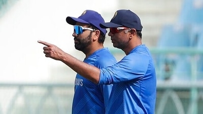 India's captain Rohit Sharma, left, listens to head coach Rahul Dravid as they watch players train during a practice session ahead of the first Twenty20 international cricket match between India and Sri Lanka in Lucknow, India. (AP)