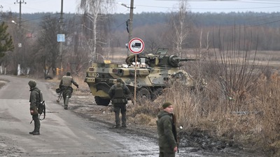 Ukrainian servicemen stand near an armored personnel carrier BTR-3 on the northwest of Kyiv. (AFP)