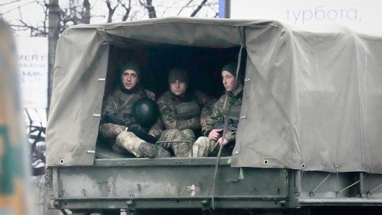 Ukrainian soldiers ride in a military vehicle in Mariupol, Ukraine on Thursday(AP)