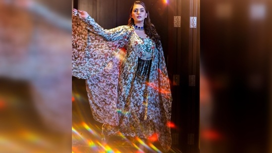 Huma Qureshi's outfit has been designed by Anamika Khanna. It comes with a floral slip dress and a matching flowy open cape.(Instagram/@iamhumaq)