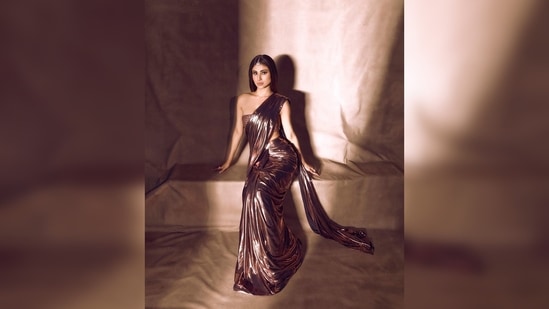 Mouni Roy's saree comes with a bandeau top with metallic pearl and cut dana work all over.(Instagram/@imouniroy)