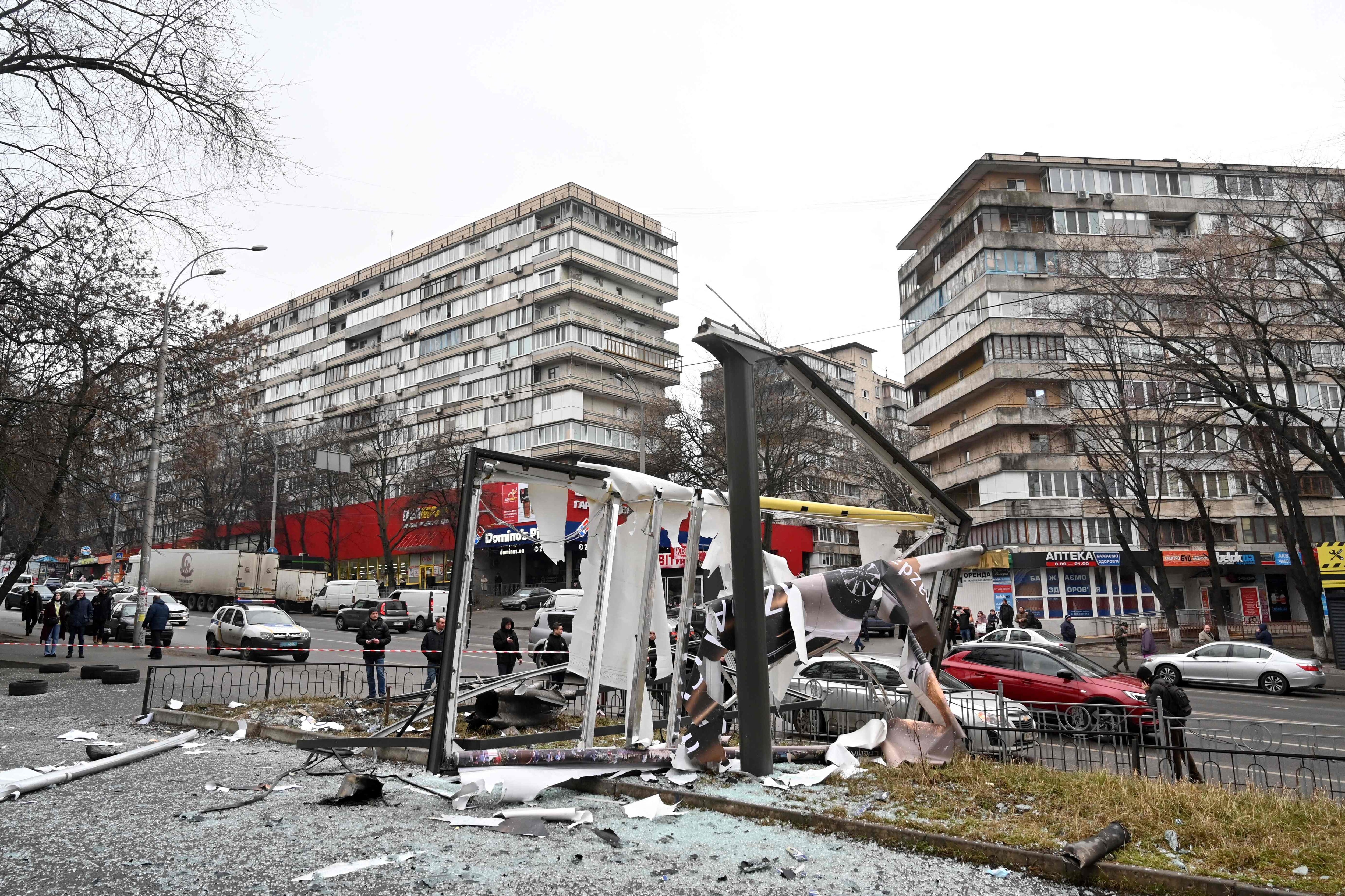 People are seen outside the cordoned off area around the remains of a shell in a street in Kyiv. Russian President Vladimir Putin announced a military operation in Ukraine with explosions heard soon after across the country and its foreign minister warning a "full-scale invasion" was underway (AFP) People are seen outside the cordoned off area around the remains of a shell in a street in Kyiv. Russian President Vladimir Putin announced a military operation in Ukraine with explosions heard soon after across the country and its foreign minister warning a "full-scale invasion" was underway (AFP)