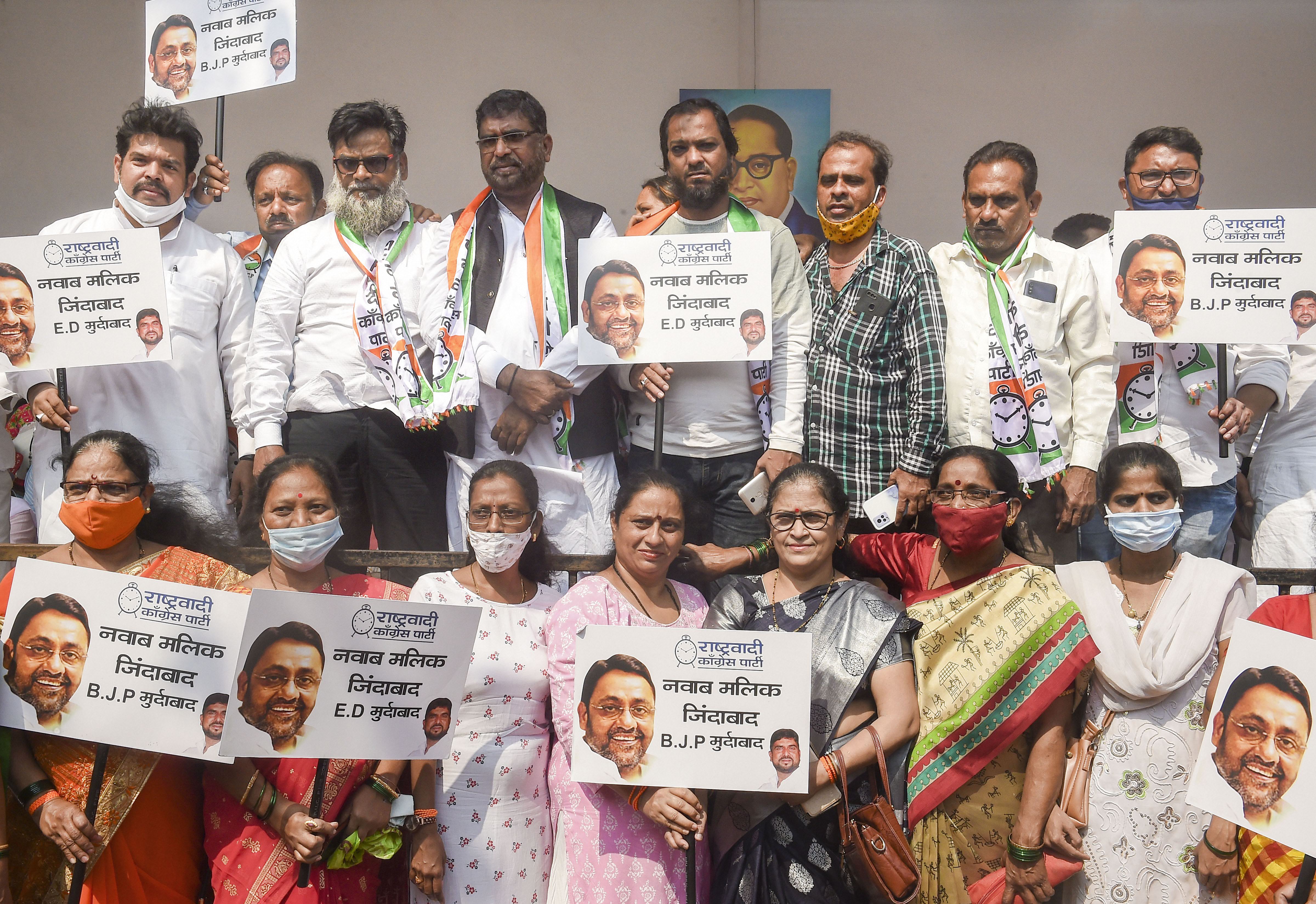 Activists of the Shiv Sena-led Maha Vikas Aghadi (MVA) protest against the arrest of state minister Nawab Malik by Enforcement Directorate, at Mahatma Gandhi Smarak in Mumbai, Thursday, Feb. 24, 2022. (PTI Photo/Kunal Patil) Activists of the Shiv Sena-led Maha Vikas Aghadi (MVA) protest against the arrest of state minister Nawab Malik by Enforcement Directorate, at Mahatma Gandhi Smarak in Mumbai, Thursday, Feb. 24, 2022. (PTI Photo/Kunal Patil)