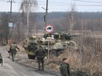 Russia-Ukraine crisis: Ukrainian servicemen stand near an armored personnel carrier BTR-3 on the northwest of Kyiv. (Photo by Daniel LEAL / AFP)(AFP) Russia-Ukraine crisis: Ukrainian servicemen stand near an armored personnel carrier BTR-3 on the northwest of Kyiv. (Photo by Daniel LEAL / AFP)(AFP)