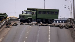 Ukrainian soldiers take position on a bridge inside the city of Kyiv.
