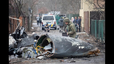 A Ukrainian Army soldier inspects fragments of a downed aircraft in Kyiv, Ukraine, on Friday. (AP)