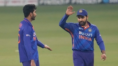 India's Venkatesh Iyer, left celebrates with India's captain Rohit Sharma the wicket of Sri Lanka's Chamika Karunaratne during the first T20I (AP)
