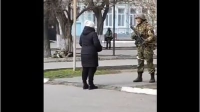 Screengrab from the viral video of a Ukrainian woman snubbing a Russian soldier.&nbsp;