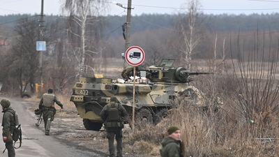 Russia-Ukraine crisis: Ukrainian servicemen stand near an armored personnel carrier BTR-3 on the northwest of Kyiv. (Photo by Daniel LEAL / AFP) (AFP)