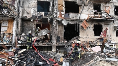 Firefighters work at a damaged residential building at Koshytsa Street, a suburb of the Ukrainian capital Kyiv, where a military shell allegedly hit on Friday (AFP) Firefighters work at a damaged residential building at Koshytsa Street, a suburb of the Ukrainian capital Kyiv, where a military shell allegedly hit on Friday (AFP)