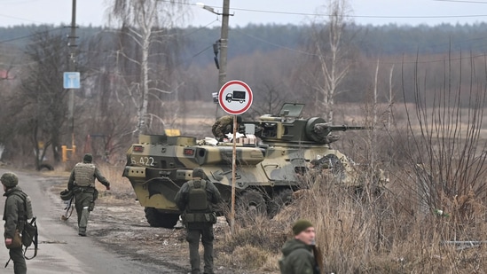 Russia-Ukraine crisis: Ukrainian servicemen stand near an armored personnel carrier BTR-3 on the northwest of Kyiv. (Photo by Daniel LEAL / AFP)(AFP)