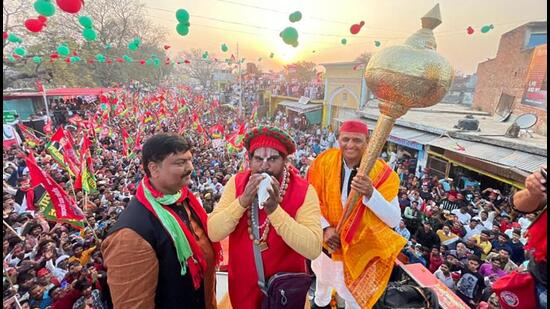 Samajwadi Party chief Akhilesh Yadav holds a mace during a road show for the UP assembly polls in Ayodhya on Friday. (ANI PHOTO)