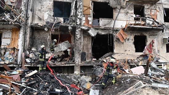 Firefighters work at a damaged residential building at Koshytsa Street, a suburb of the Ukrainian capital Kyiv, where a military shell allegedly hit on Friday(AFP)