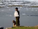 A ragpicker stands on the banks of the river Yamuna in New Delhi. A ragpicker stands on the banks of the river Yamuna in New Delhi.
