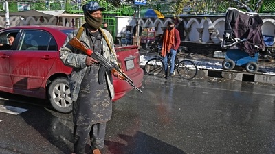 A Taliban fighter stands guard in Kabul during a women's protest for right to education, jobs and political representation. (AFP) A Taliban fighter stands guard in Kabul during a women's protest for right to education, jobs and political representation. (AFP)